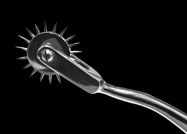Metal prong tool on a black background