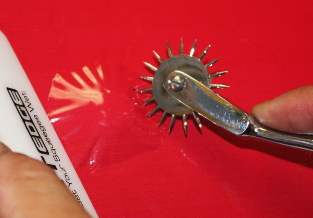 Metal wheel with spikes on a red background