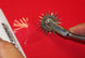 Metal wheel with spikes on a red background