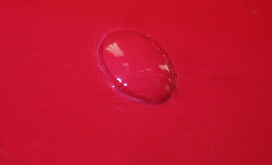 Water droplet on a red surface