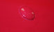 Water droplet on a red surface