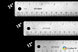Three metal rulers with measurements in inches and millimeters on a black background.