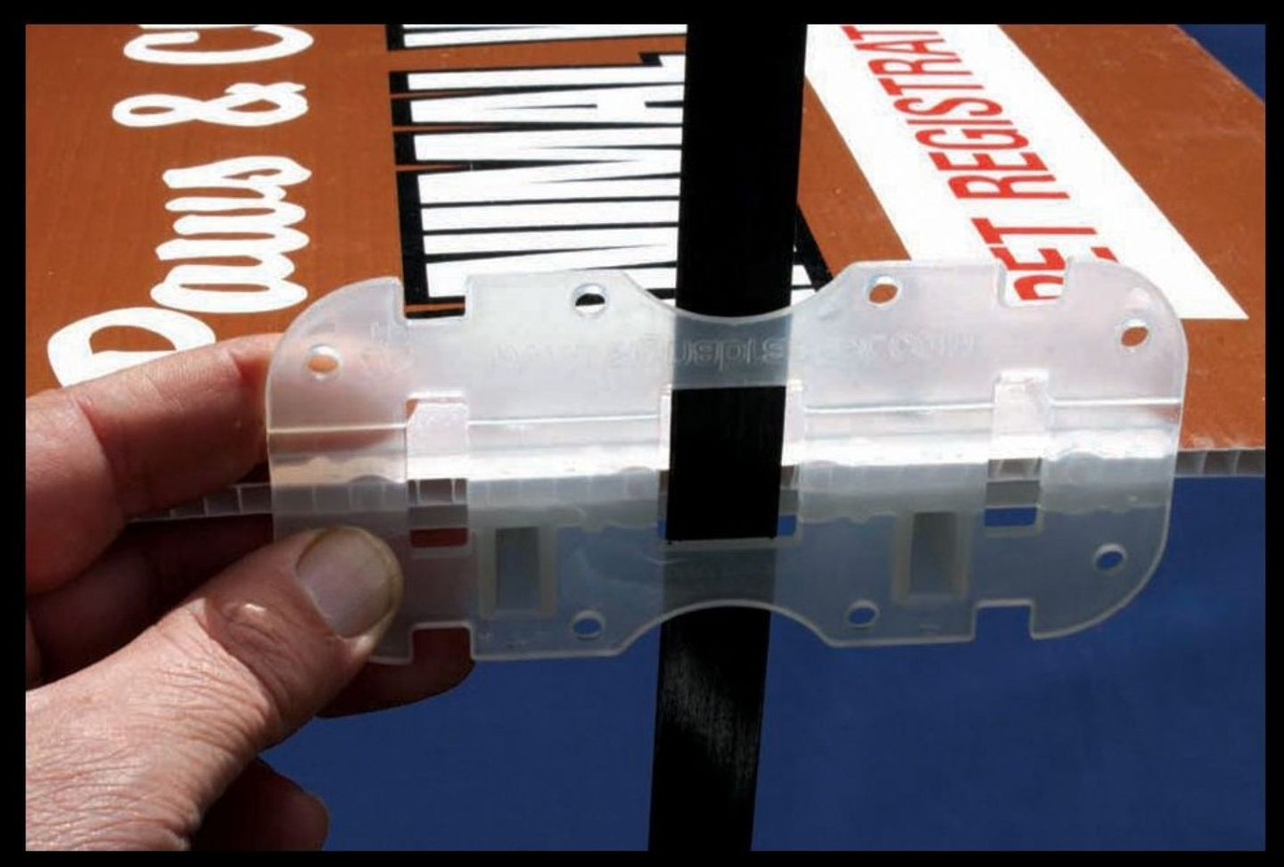 Clear plastic tool held by a hand with a blurred background