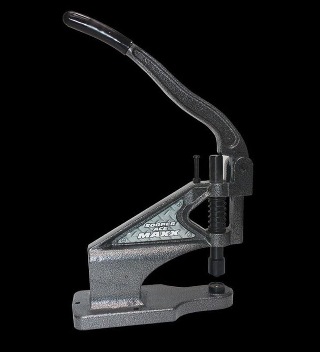 Metal die cutting machine on a black background