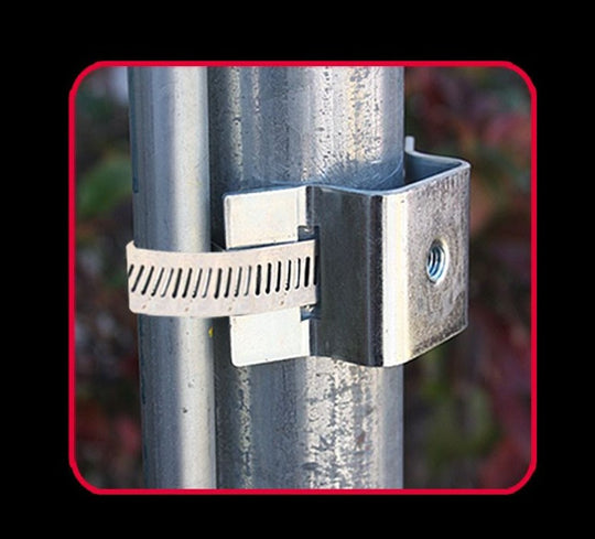 Metal bracket attached to a cylindrical metal post with a blurred natural background