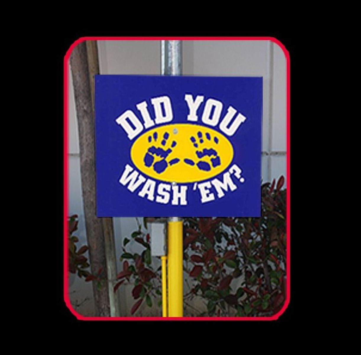 Blue sign with yellow circle and paw prints on a pole against a tiled wall background