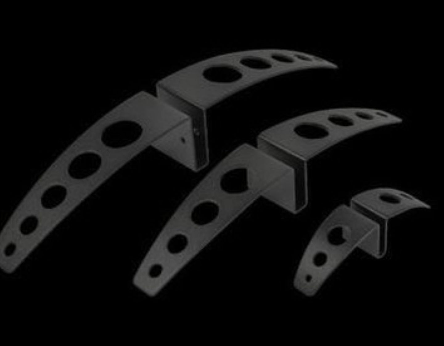 Metal brackets with multiple holes on a black background