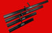 Set of black metal skis with branding on a red background