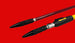 Two cylindrical objects with black and yellow ends on a red background