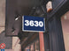 Neon sign with the number '3630' on a building exterior.