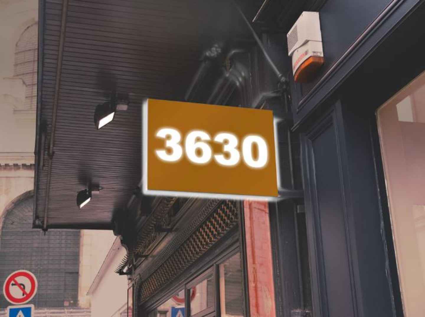 Street sign with the number '3630' on a building facade.