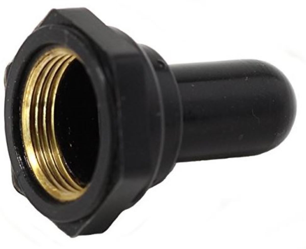 Black and brass toggle switch fitting on a white background