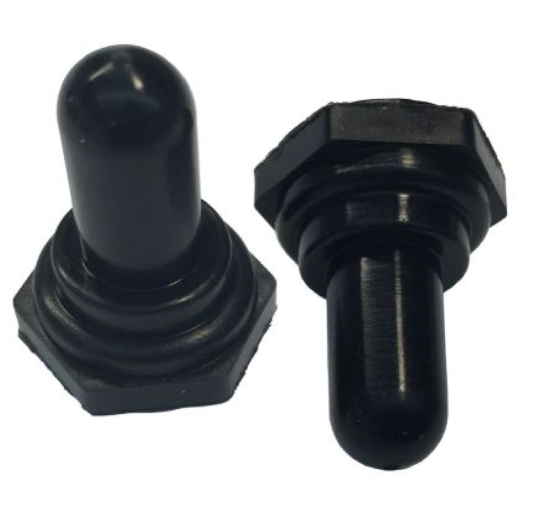 Two black metal toggle boots on a white background