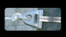 Metallic water faucet with water flowing onto a stone surface.