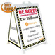 A-frame sign with 'Be Bold!' text and branding details on a white background