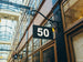 Building facade with a number 50 sign in an indoor shopping arcade.