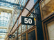 Building facade with a number 50 sign in an indoor shopping arcade.
