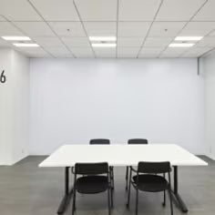 Conference room with a whiteboard and table with chairs
