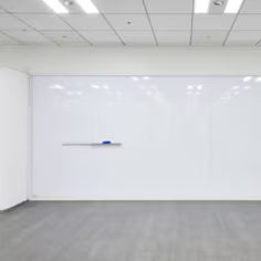 Empty room with a whiteboard on a wall