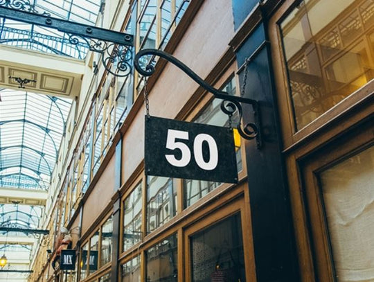 Building facade with a sign displaying the number 50