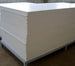 Stack of white and beige panels on a wooden pallet