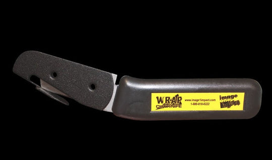 Black folding knife with a yellow label on a black background