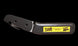 Black folding knife with a yellow label on a black background