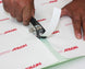 Person using a paper cutter on Arlon branded paper