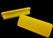Two yellow plastic tools with branding on a black background