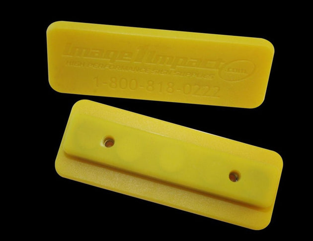 Two yellow plastic sponges with a brand logo on a black background