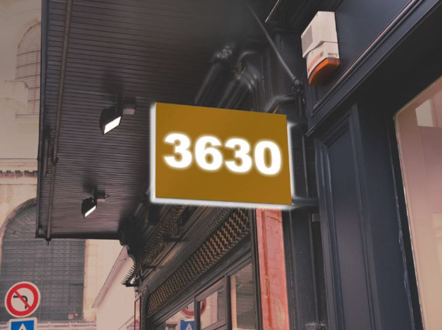 Street sign with the number '3630' on a building facade.